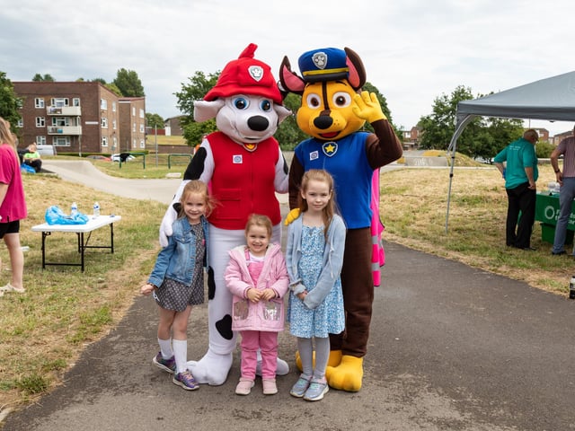 Sisters Katie Payne (7), Isabelle Payne (3) and Amelia Payne (8) with some of the friendly characters at the Party in the Warren. Picture: Mike Cooter (080723)