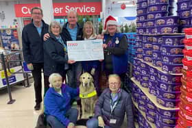 Friends fur-ever: Tesco colleagues present Guide Dogs volunteers with essential funding.