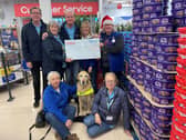 Friends fur-ever: Tesco colleagues present Guide Dogs volunteers with essential funding.