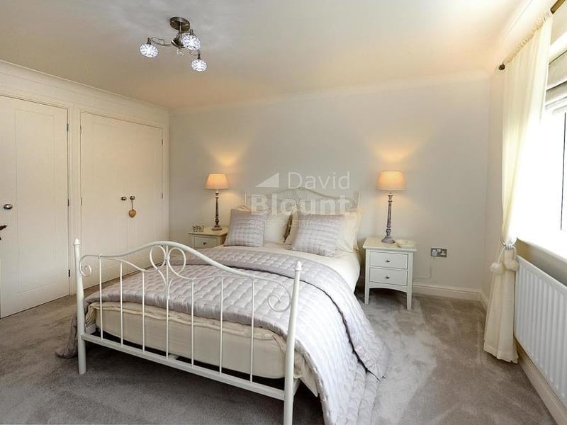 Another view of the second bedroom. It shows the three sets of double wardrobes, which add to the four sets in the main bedroom.