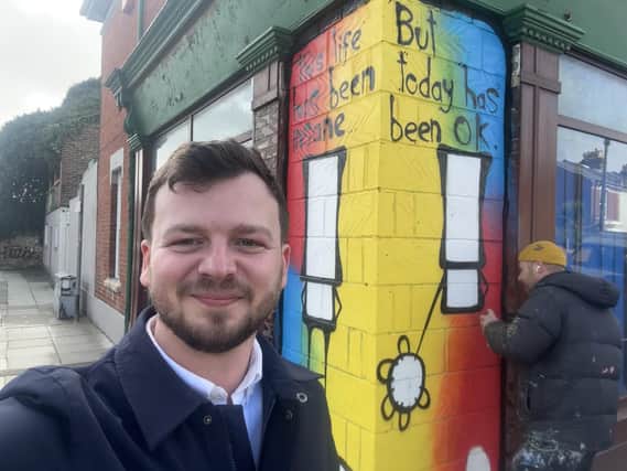 Portsmouth City Council candidate Joshua Allen poses in front of My Dog Sighs' latest creation. Picture: Contributed