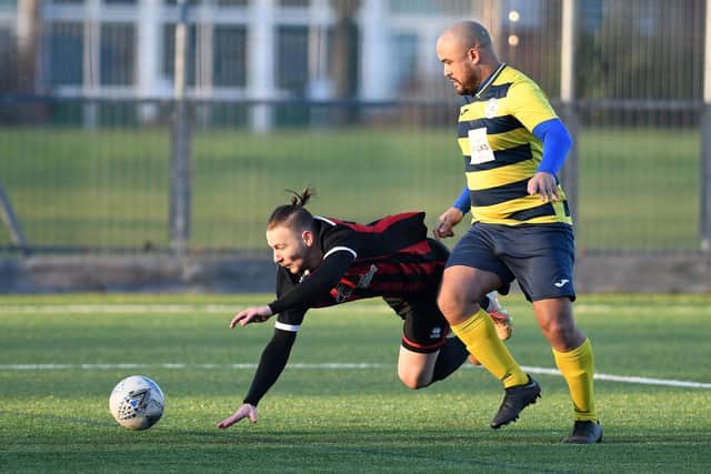 Ali Alpay takes a tumble after a challenge from Mike Mallory.
Picture: Neil Marshall