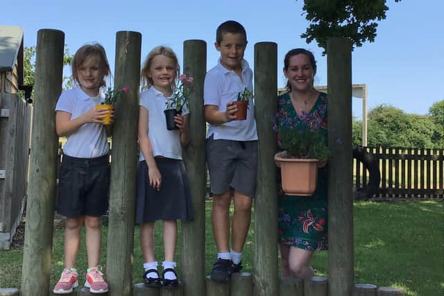 Assistant Head teacher, Charlotte Tighe, with pupils, from left, Millie Costa, Emma Blackwell and Daniel Morgan, all 6, who have been reading their favourite books to their plants