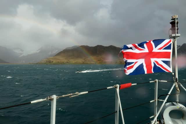 The Union Jack flutters as HMS Forth anchors off South Georgia.