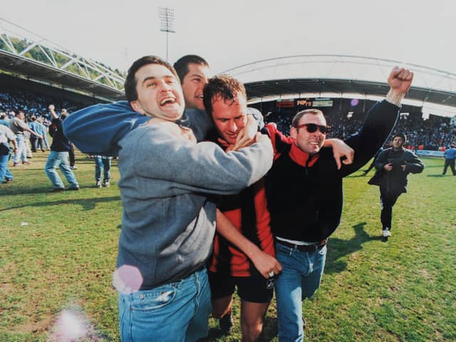 Pompey fans celebrate on the pitch at Huddersfield Town in 1996. One of the photos featured in the forthcoming exhibition at the University of Portsmouth's Ravelin Sports Centre. Picture: Steve Reid