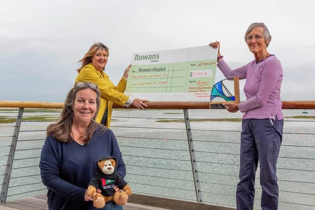 Club Commodore Joanna Lewis with Ann Kent giving the fundraising cheque to Ruth White, CEO of the Rowans.