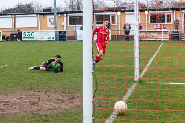 Evan Harris scores the second of his four goals for Horndean Red at AFC Portchester U18s last Sunday. Picture: Mike Cooter
