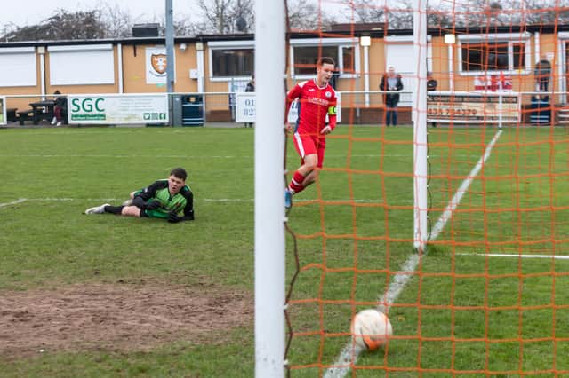 Evan Harris scores the second of his four goals for Horndean Red at AFC Portchester U18s last Sunday. Picture: Mike Cooter