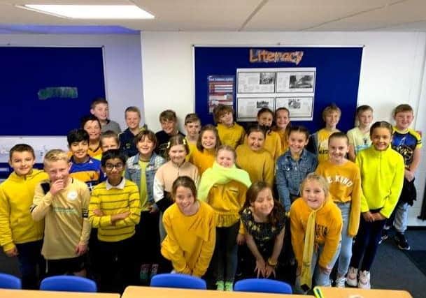 Gomer Junior School Year 6 pupils dressed in yellow to support World Mental Health Day.