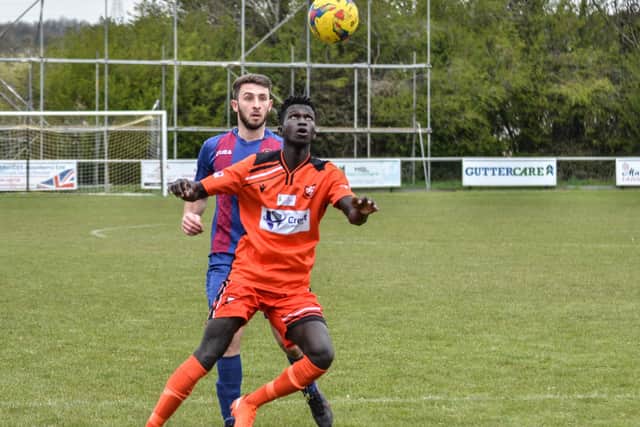 Portchester's Lamin Jatta (orange) keeps his eyes on the ball against US Portsmouth. Picture: Daniel Haswell.