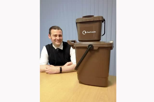 Cllr Dave Ashmore, Cabinet Member for Environment and Climate Change at Portsmouth City Council with food waste caddies