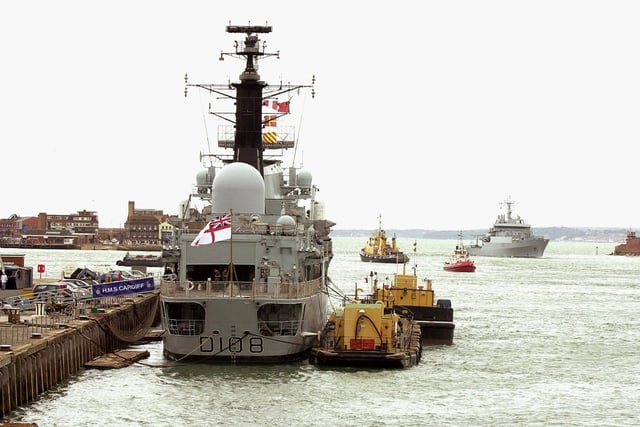 HMS Cardiff (left) - sits alongside South Railway Jetty as the new M.V. Enterprise (right) comes through the Portsmouth Harbour entrance  17th July 2003 Picture: Malcolm Wells/The New Portsmouth ( 033561-183 )