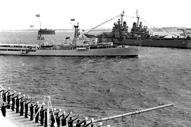 HMS Surprise passes USS Baltimore
During the 1953 Fleet Review  HMS Surprise passes between the USS Baltimore and HMS Vanguard.