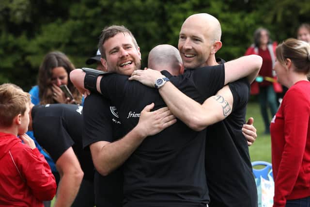 Some of the relay runners embrace after crossing the finishing line.

Picture: Sam Stephenson.