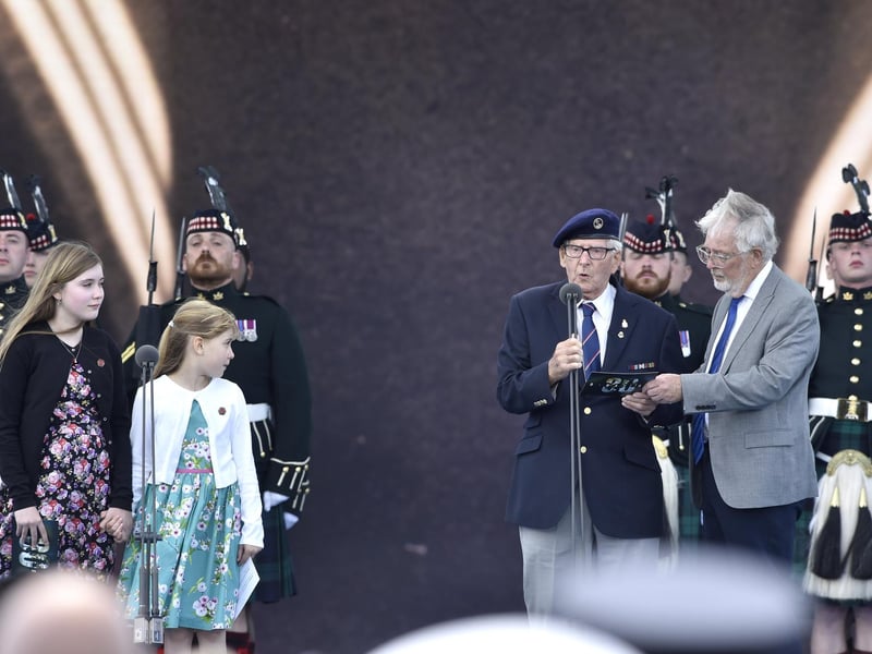 D Day 80 commemorations on Southsea Common, Southsea, on Wednesday, June 5, 2024.
Pictured is: Veteren Eric Bateman with his great granddaughters on stage.
Picture: Sarah Standing (050624-3796)