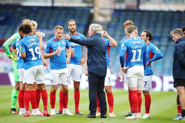 Kenny Jackett addresses Pompey's team during a water break in Friday's play-off semi-final first leg against Oxford. Picture: Joe Pepler
