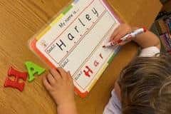 Michelle Duffy's son, Harley, using one of her products to write his name.