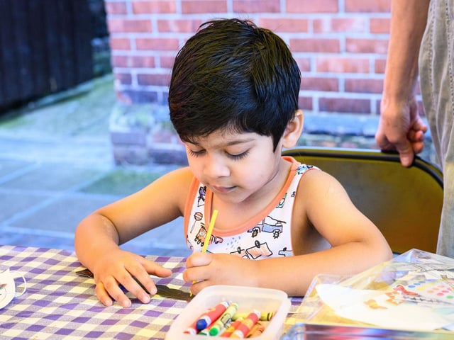 Pictured is: Eijaz gets to grips with craft work at the Family festivalPicture: Keith Woodland (100921-19)