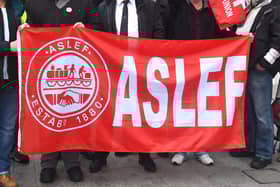 A flag on an Aslef picket line. Train drivers at eight rail companies are to stage a 24-hour Saturday strike later this month in pay disputes, threatening more disruption to services.