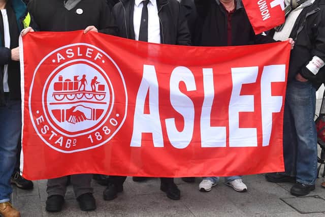 A flag on an Aslef picket line. Train drivers at eight rail companies are to stage a 24-hour Saturday strike later this month in pay disputes, threatening more disruption to services.