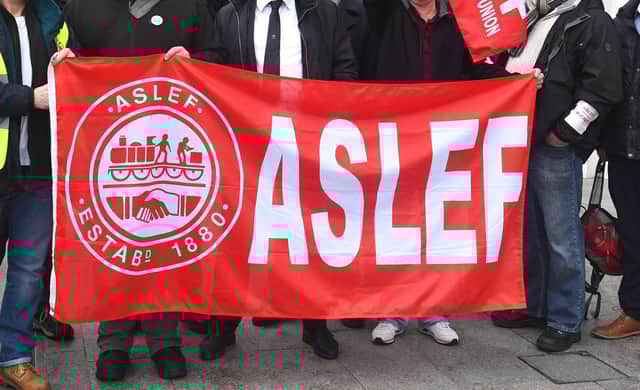 A flag on an Aslef picket line. Train drivers at eight rail companies are to stage a 24-hour Saturday strike later this month in pay disputes, threatening more disruption to services.