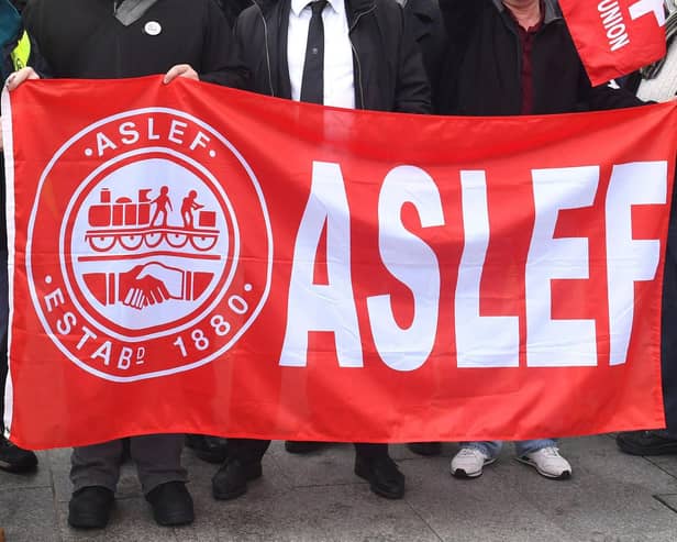 A flag on an Aslef picket line. Train drivers at eight rail companies are to stage a 24-hour Saturday strike later this month in pay disputes, threatening more disruption to services.