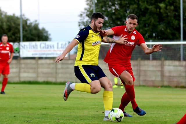 Gosport striker Bradley Lethbridge (yellow) in action against Horndean. Picture: Tom Phillips