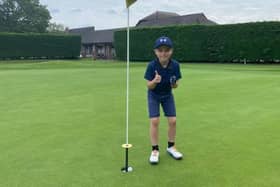 Isaac Haunstrup, 6, celebrates his hole in one at Waterlooville Golf Club