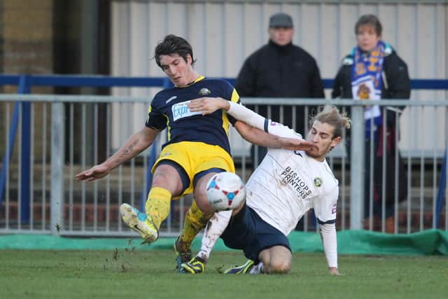 Brett Poate, left, in action for Gosport against Hawks' Scott Jones. Picture by Dave Haines.