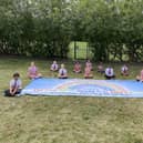 Pupils from St Paul's Primary School with the giant handprint rainbow they created to thank key workers.