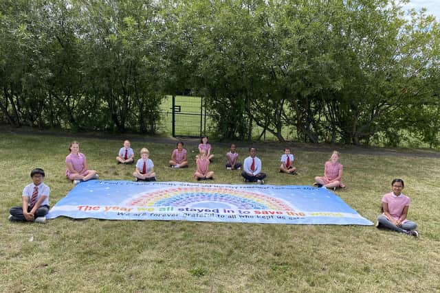 Pupils from St Paul's Primary School with the giant handprint rainbow they created to thank key workers.