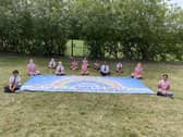 Pupils from St Paul's Primary School with the giant handprint rainbow they created to thank key workers.