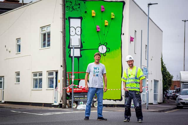 Artist MyDogSighs, painting a new mural on the Portsmouth Carers building on Francis Avenue, Portsmouth on behalf of Wilder Portsmouth on 28 September 2020Pictured: Andy Ames of Wilder Communities with artist, MyDogSighs in front of the mural.Picture: Habibur Rahman