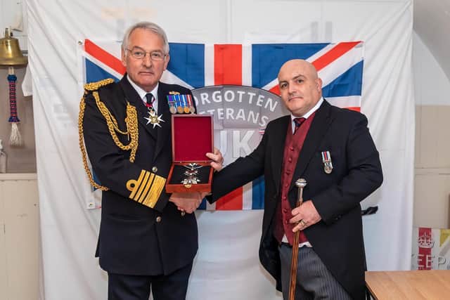 Gary Weaving (Founder and CEO of Forgotten Veterans) receives his award from Admiral Sir Jonathon Band (former First Sea Lord). Picture: Mike Cooter (011221)