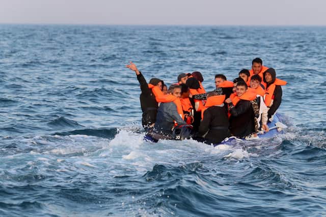 A group of people thought to be migrants crossing the Channel in a small boat headed in the direction of Dover, Kent. Picture by Gareth Fuller/PA