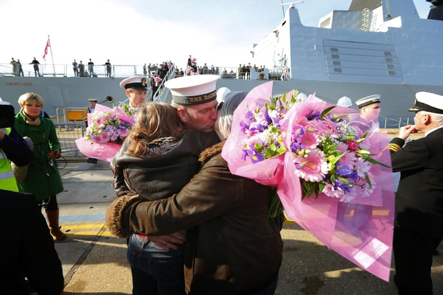 A crew member kisses family members on the dock side after the Type 45 Destroyer HMS Dauntless returned home to Portsmouth from her maiden deployment. PRESS ASSOCIATION Photo. Picture date: Tuesday October 30, 2012. Hundreds of family members lined the quayside to welcome home the crew of one of the Royal Navy's most advanced warships as it returned from its maiden deployment. HMS Dauntless returned from its seven-month voyage circumnavigating the Atlantic Ocean. See PA story DEFENCE Dauntless. Photo credit should read: Chris Ison/PA Wire