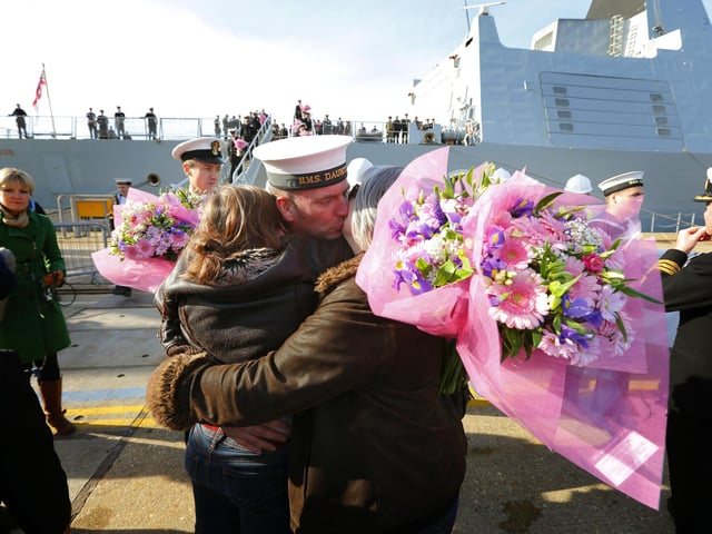 A crew member kisses family members on the dock side after the Type 45 Destroyer HMS Dauntless returned home to Portsmouth from her maiden deployment. PRESS ASSOCIATION Photo. Picture date: Tuesday October 30, 2012. Hundreds of family members lined the quayside to welcome home the crew of one of the Royal Navy's most advanced warships as it returned from its maiden deployment. HMS Dauntless returned from its seven-month voyage circumnavigating the Atlantic Ocean. See PA story DEFENCE Dauntless. Photo credit should read: Chris Ison/PA Wire