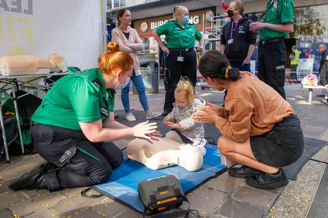 CPR training day for the public at Commercial Road, Portsmouth for Restart a Heart day on Friday 15th October 2021

Pictured: Amy Hughes teaching Winter Blue, 2, and her auntie Saffron Godfrey how to do chest compressions.

Picture: Habibur Rahman