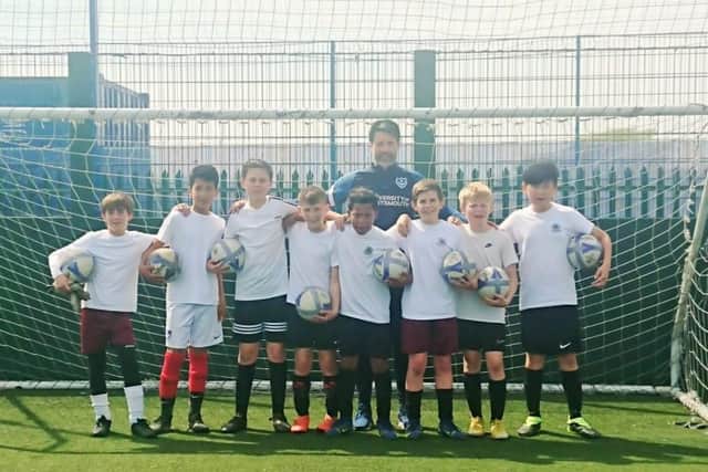 Danny Cowley lead training session at Portsmouth FC's training ground, in Hilsea, for the Meon Junior School football team, ahead of their Utilita Kids Cup final at Wembley, on May 21. Pictured is Danny Cowley, and the Meon Junior School squad on May 6, 2022. The players include Leo Higgins and Lewis Hamza, aged 10, alongside Lorenzo jay, Teddy Nightingale, Freddie Seabrook, Rafael Taylor-Stoakes, Anbiya Habibi, and Leon Young, all aged 11. Picture: Freddie Webb.