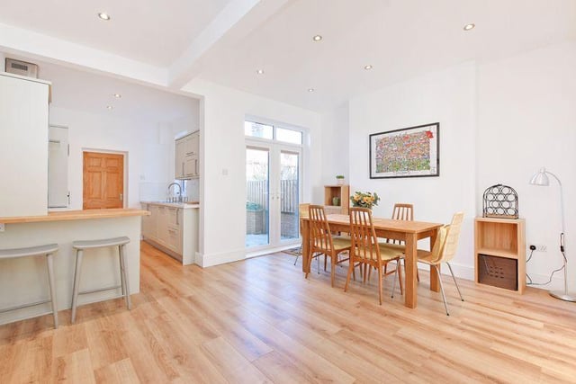 The kitchen, living and dining area has wood-effect laminate flooring throughout.