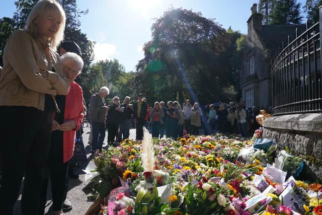 Well-wishers outside Balmoral in Scotland on Saturday following the death of Queen Elizabeth II on Thursday. Picture: Owen Humphreys/PA Wire