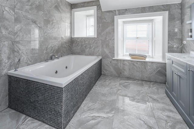 The main bathroom benefits from a jacuzzi bath and walk in shower.