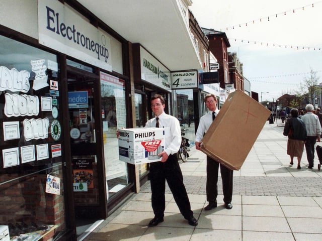 David Halewood (left) and Peter Owens of Electronequip carry boxes into the store in West Street in May 1992.