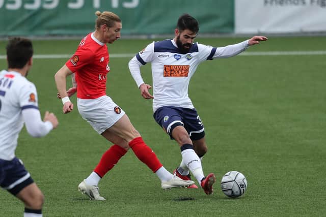 Aryn Williams wins the ball on his first Hawks start against Ebbsfleet. Photo by Dave Haines