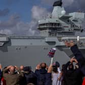 People waving at HMS Queen Elizabeth as she passes the Round Tower in Old Portsmouth today
Picture: Habibur Rahman