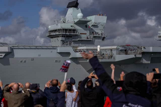 People waving at HMS Queen Elizabeth as she passes the Round Tower in Old Portsmouth today
Picture: Habibur Rahman