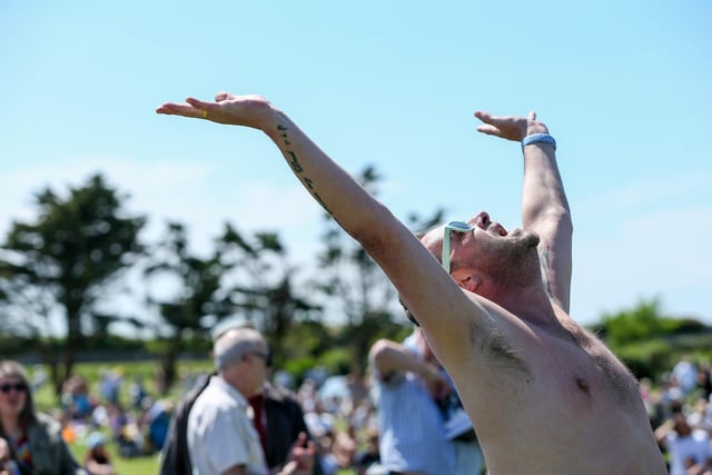 A music fan salutes the sun at the Live at the Bandstand event.Picture: Chris  Moorhouse (250524-19)