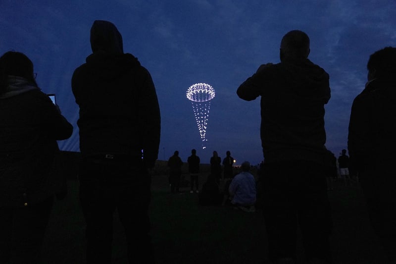 Drones make a parachute during a drone display telling the story of D-Day. Photo: Andrew Matthews/PA Wire