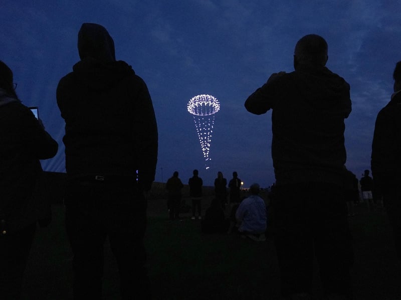 Drones make a parachute during a drone display telling the story of D-Day. Photo: Andrew Matthews/PA Wire