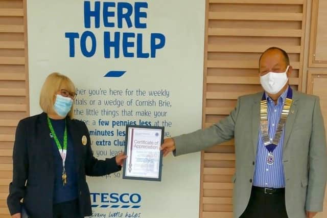 Liz Jones from Havant Tesco receiving the certificate of appreciation from Havant Lions’ president Ian Ranscombe